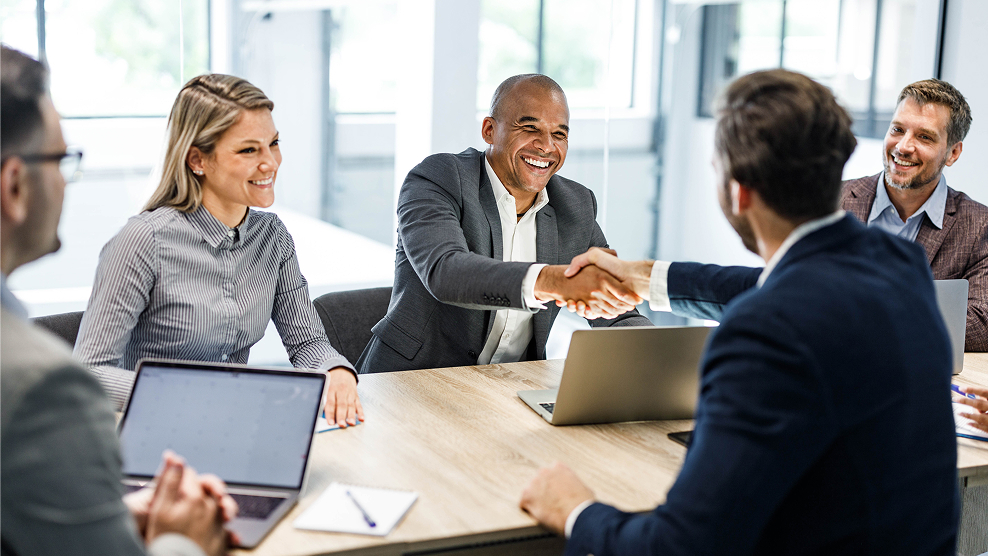 Business executives reaching an agreement with their benefit adviser.